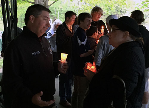 Jon Gore talks with a well-wisher at the candlelight vigil in honor of his brother, Michael Nicoloro.